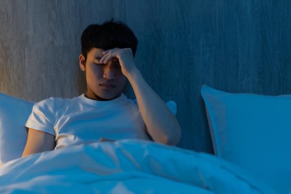 close up of young man is worrying a<em></em>bout something at night