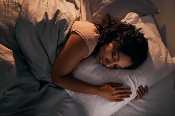 High angle shot of a young woman sleeping during the night