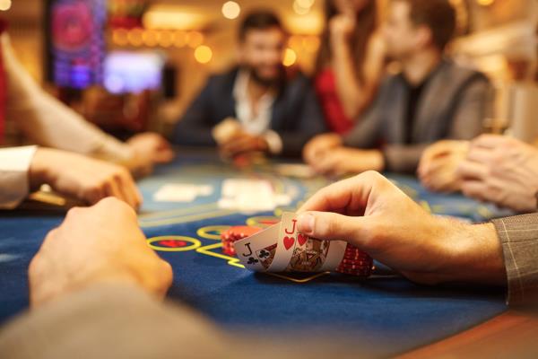 A closeup of a player's pocket jack cards in a game of poker at a casino