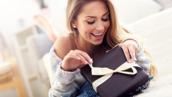 young white woman opening gift box