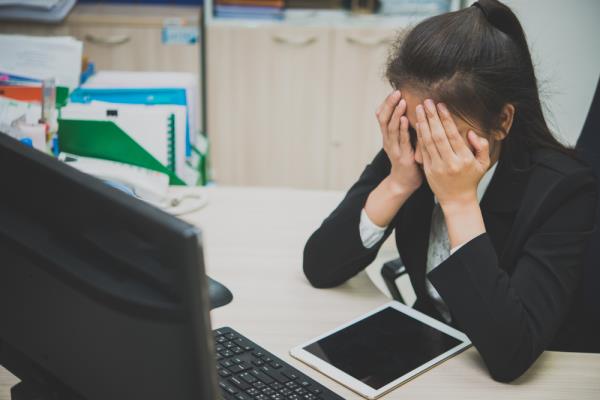 stock photo of woman frustrated at work.